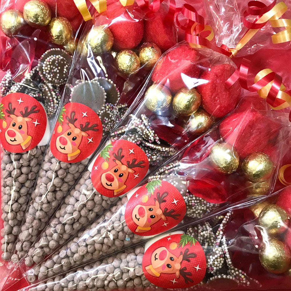 Packaged sweet cones with a reindeer design, containing a variety of sweets, wrapped in transparent plastic.