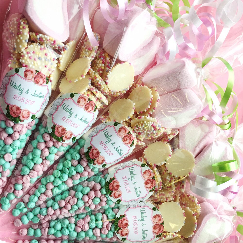 Bouquet of sweets with floral designs and personalised labels, surrounded by pink and green ribbons.