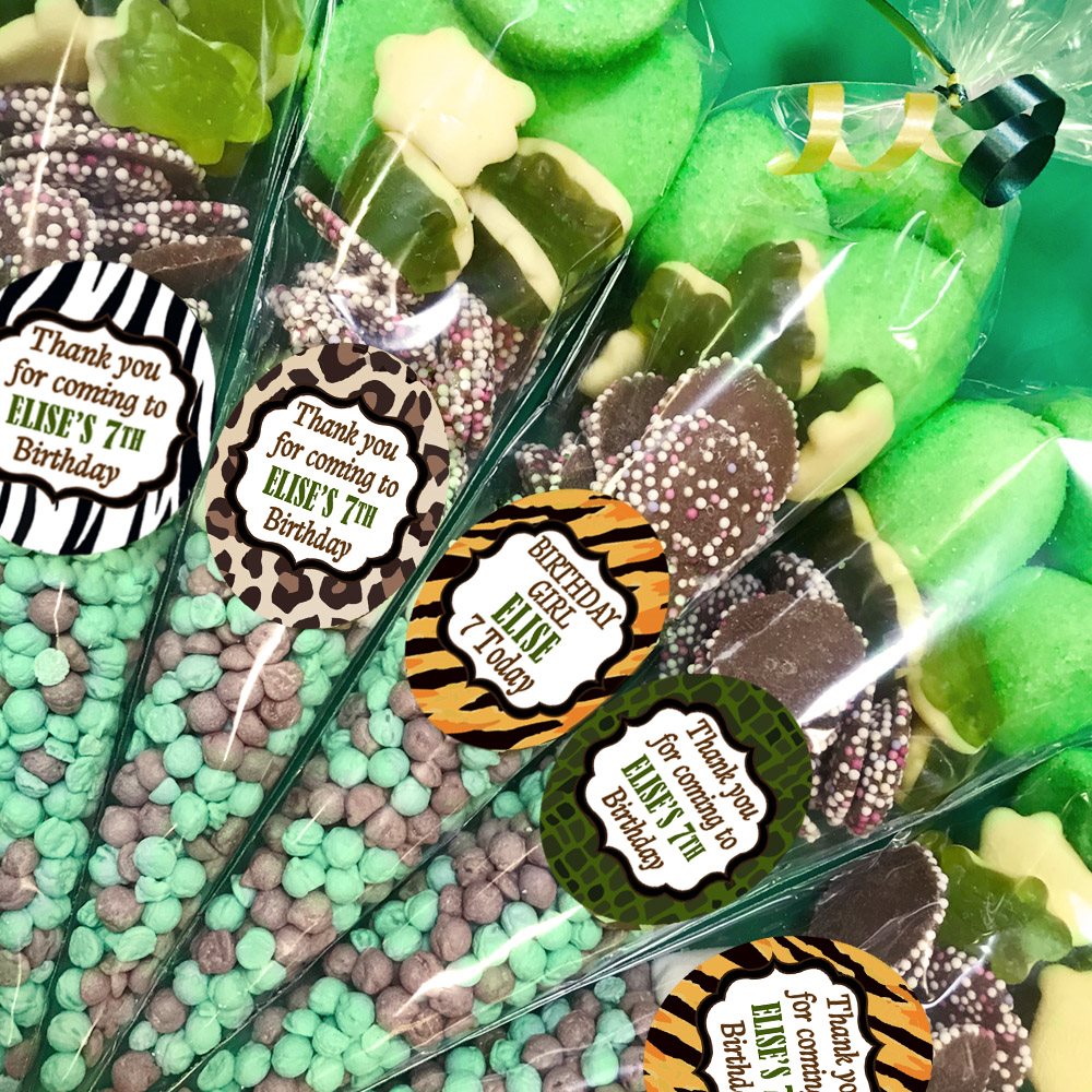 Packaged treats with birthday-themed labels on a green background