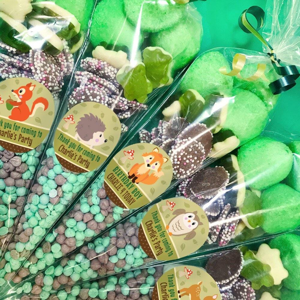 Packaged sweet cones with various animal designs, each cone is adorned with a label featuring a different woodland animal illustration.