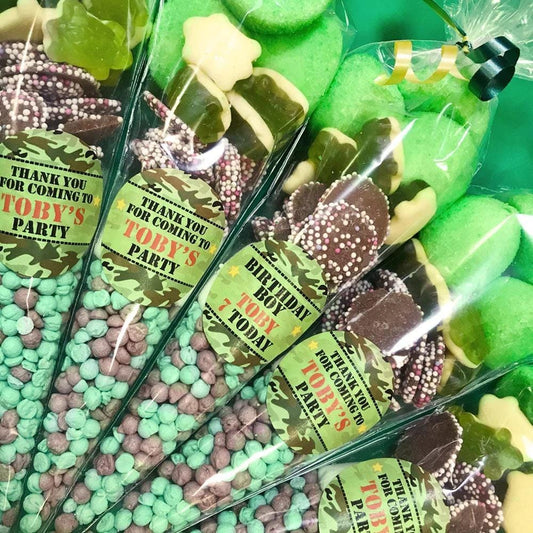 Pre-filled sweet cones with camouflage pattern decorations and personalized labels for a military-themed party.