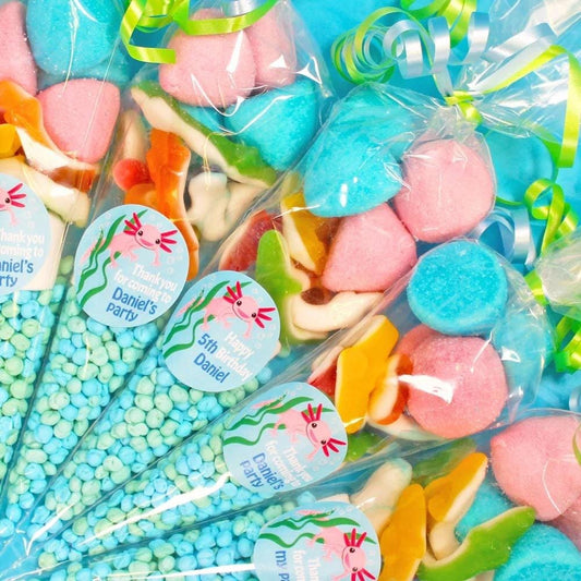 Pre-filled sweet cones with various colourful candies visible, packaged in clear wrapping with printed labels, including Axolotl-themed decorations.