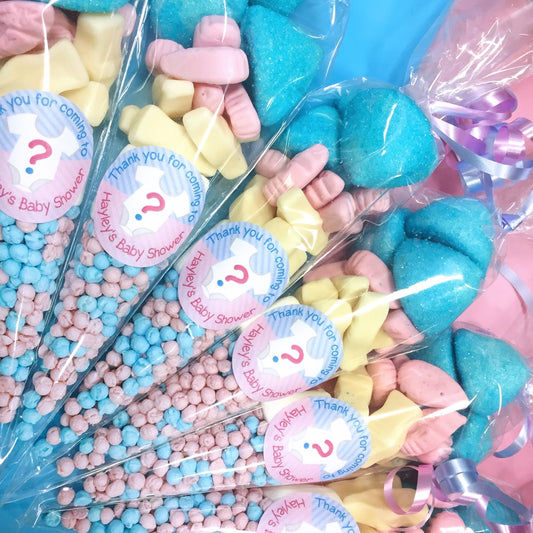 Colourful sweet bags with baby shower-themed labels in clear packaging.