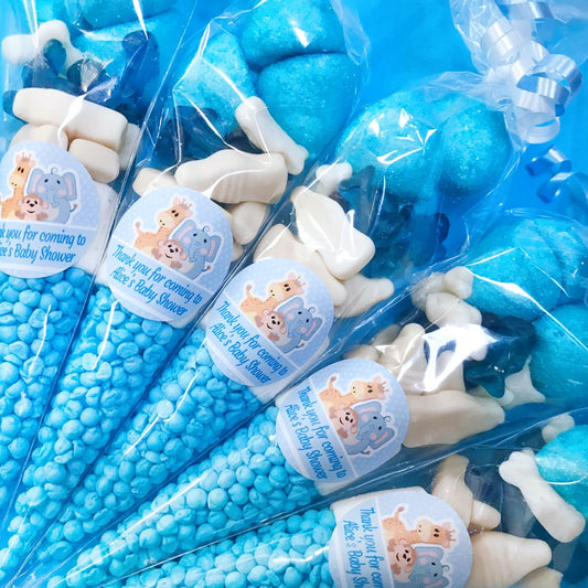 Blue and white candy cones in clear packages with baby shower labels.