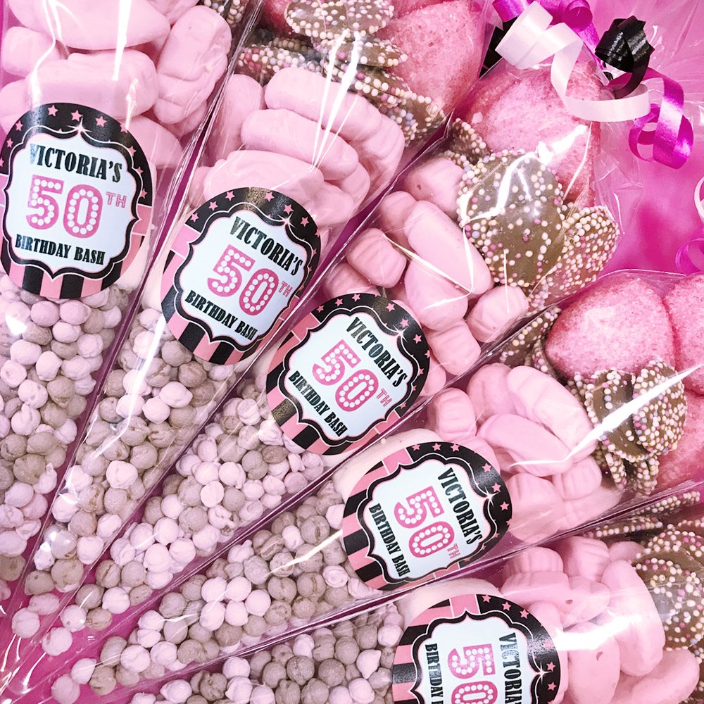 Pink candy cones with  Birthday Bash' labels on a pink background.