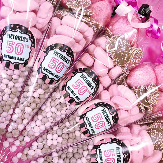 Pink candy cones with  Birthday Bash' labels on a pink background.