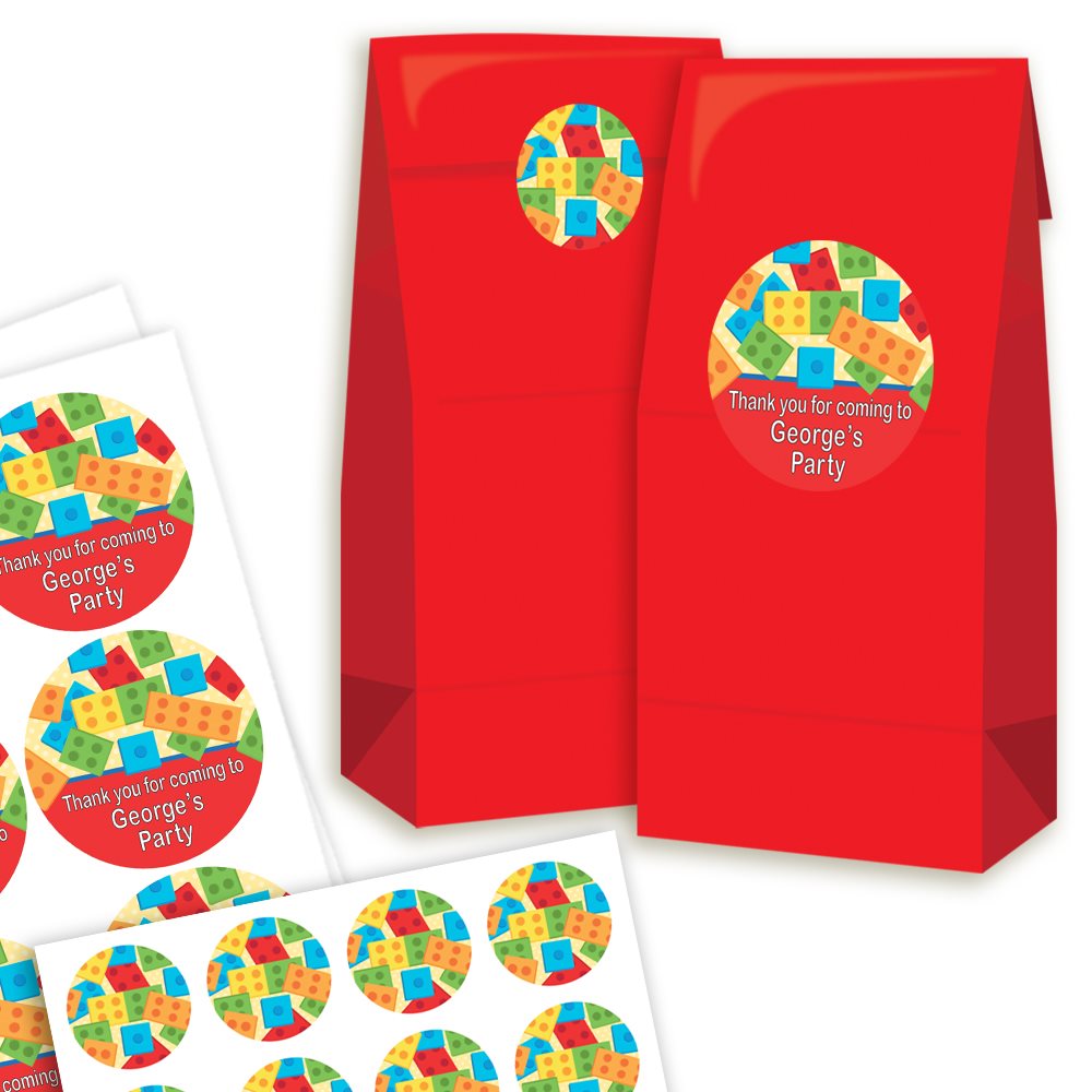 Red party favour bags with colourful round labels on a white background