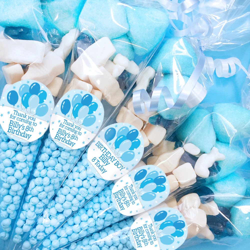 Party favors with blue and white balloons, ribbons, and personalized labels for a birthday celebration.