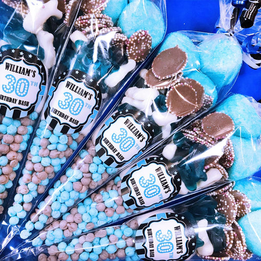 Party favors with personalized labels for a birthday bash.