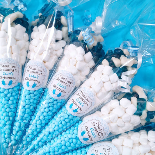 Blue and white candy cones with personalized labels on a blue background