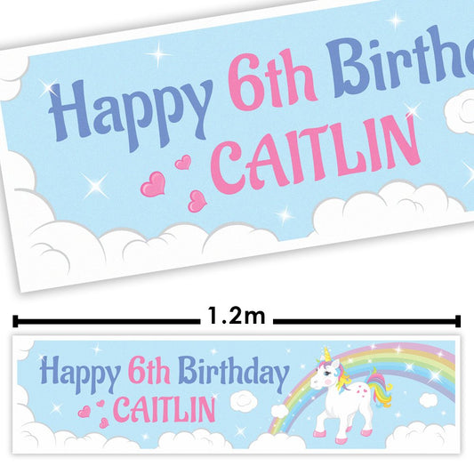 Happy 6th Birthday banner for Caitlin with a unicorn and rainbow design on a light blue background.