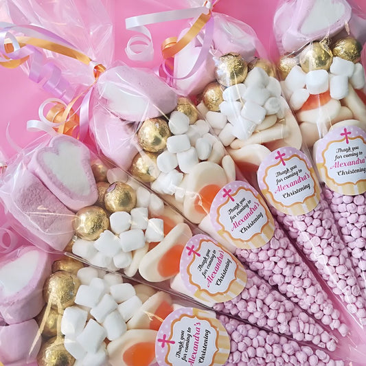 Assorted sweet cones with personalised labels with a christening theme.