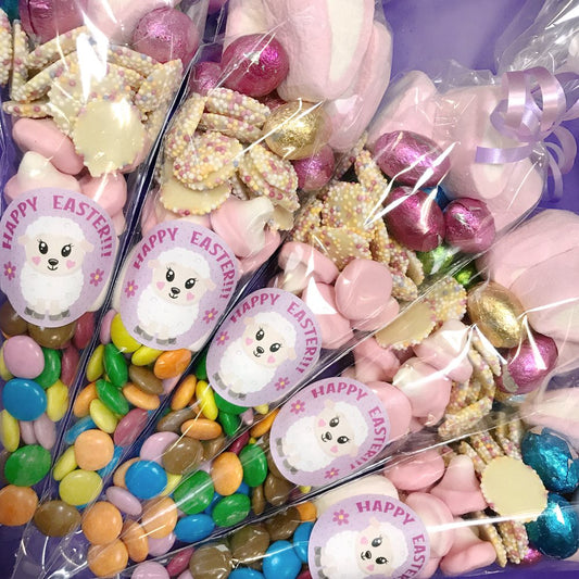 Assorted Easter candy in clear bags with 'Happy Easter' labels featuring a lamb design.