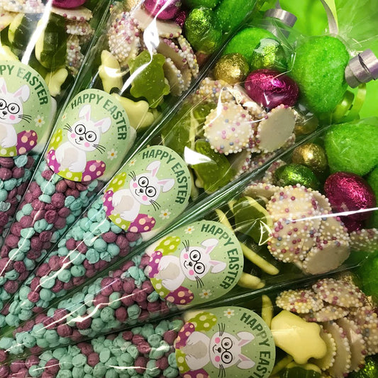 Packaged Easter sweets with colourful chocolate eggs and 'Happy Easter' rabbit labels.