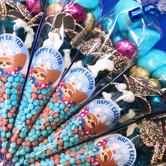 Decorative Easter candy cones with 'Happy Easter' labels featuring cartoon sloths.
