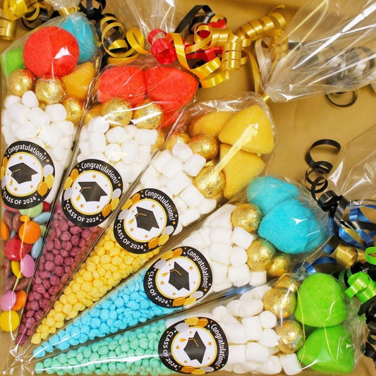 A selection of pre-filled sweet cones with various colorful candies and decorations, each cone with a personalized graduation sticker.