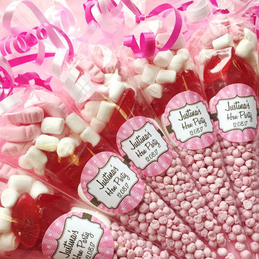 Pink and red candy bags with marshmallows and personalized labels.