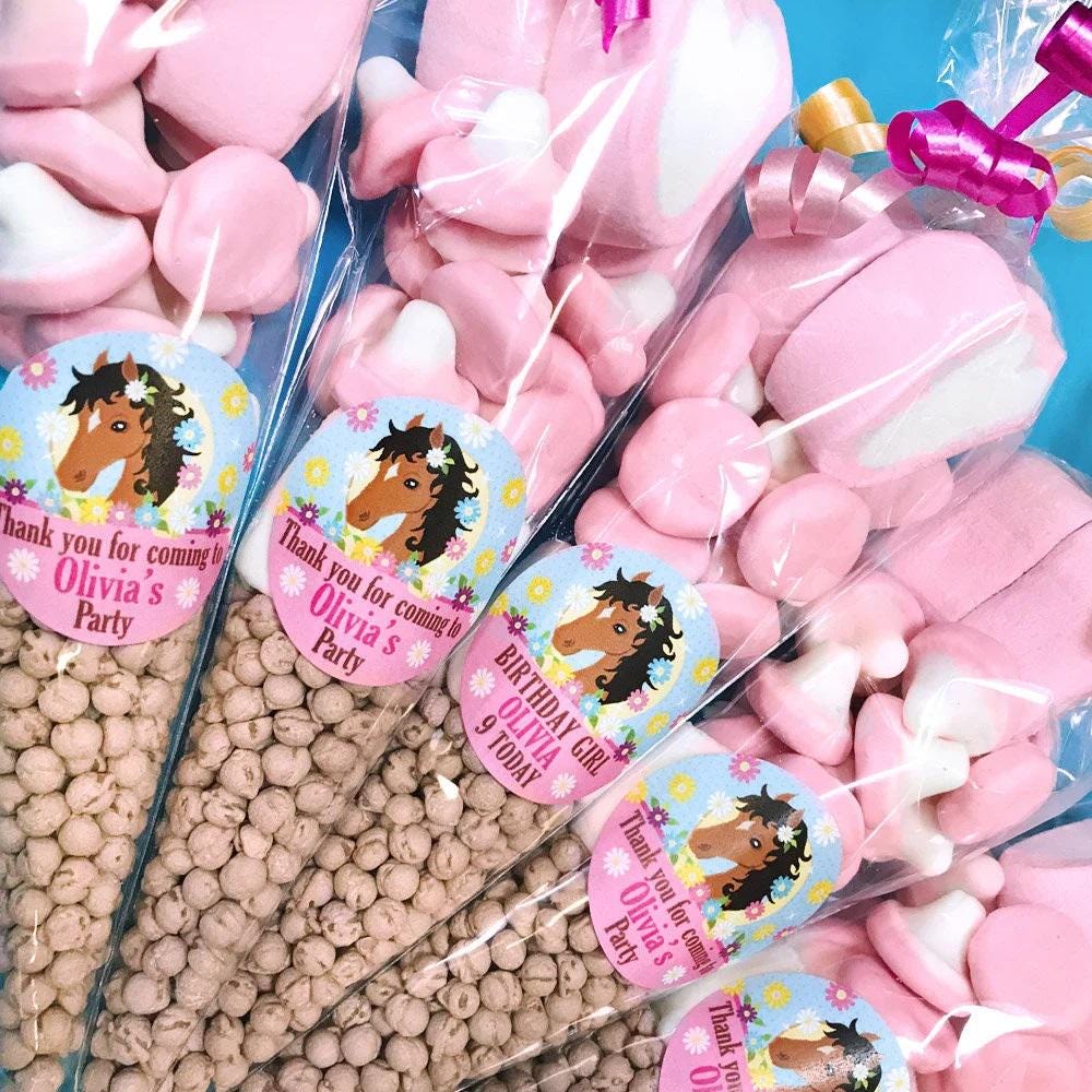 Pre-filled sweet cones for children's pony-themed parties, with custom labels featuring pony illustrations.