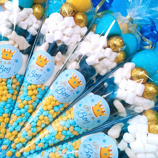 Decorative candy cones with 'It's a Boy' labels, blue, yellow, and white colors.