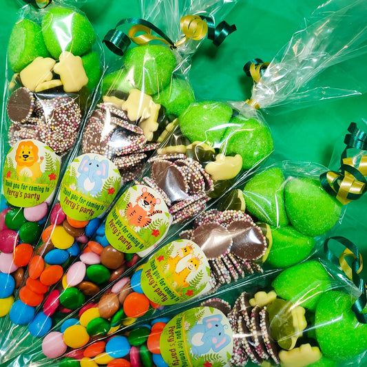 Assorted candy bags with animal-themed labels on a green background