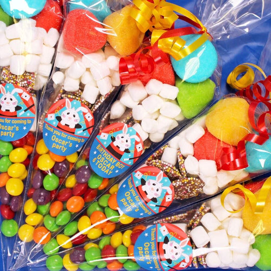 Assorted sweet cones with colorful candy visible, each labeled with a sticker featuring cartoon characters.