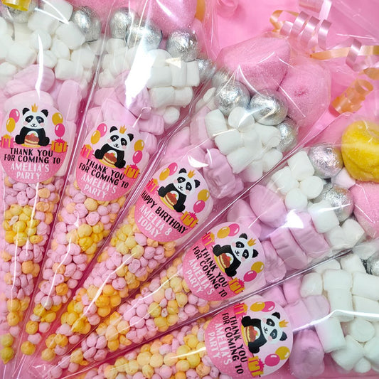 Packaged candy sticks with panda-themed labels on a white background