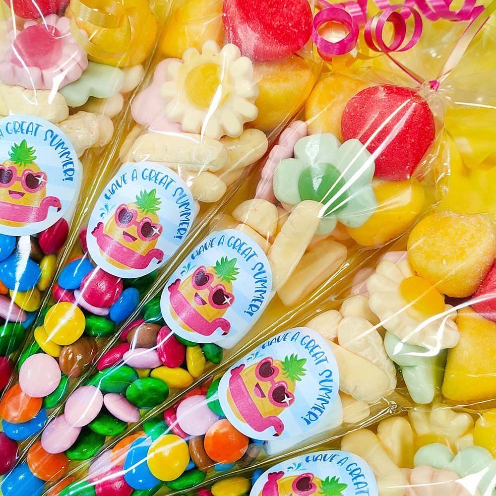 Colorful candy assortment in clear packaging with pineapple-themed stickers.
