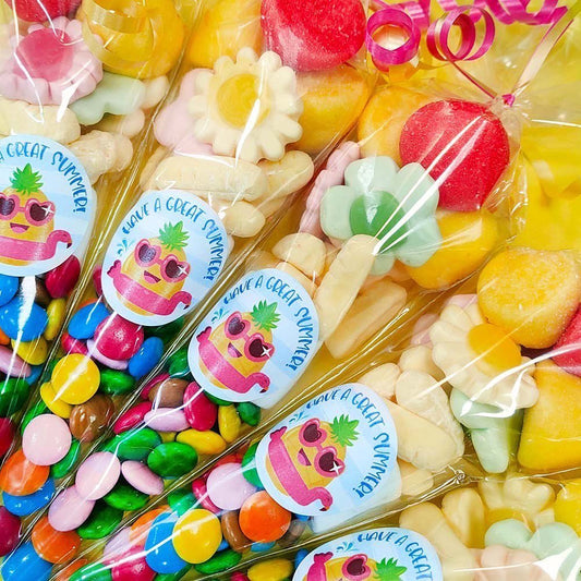 Colorful candy assortment in clear packaging with pineapple-themed stickers.