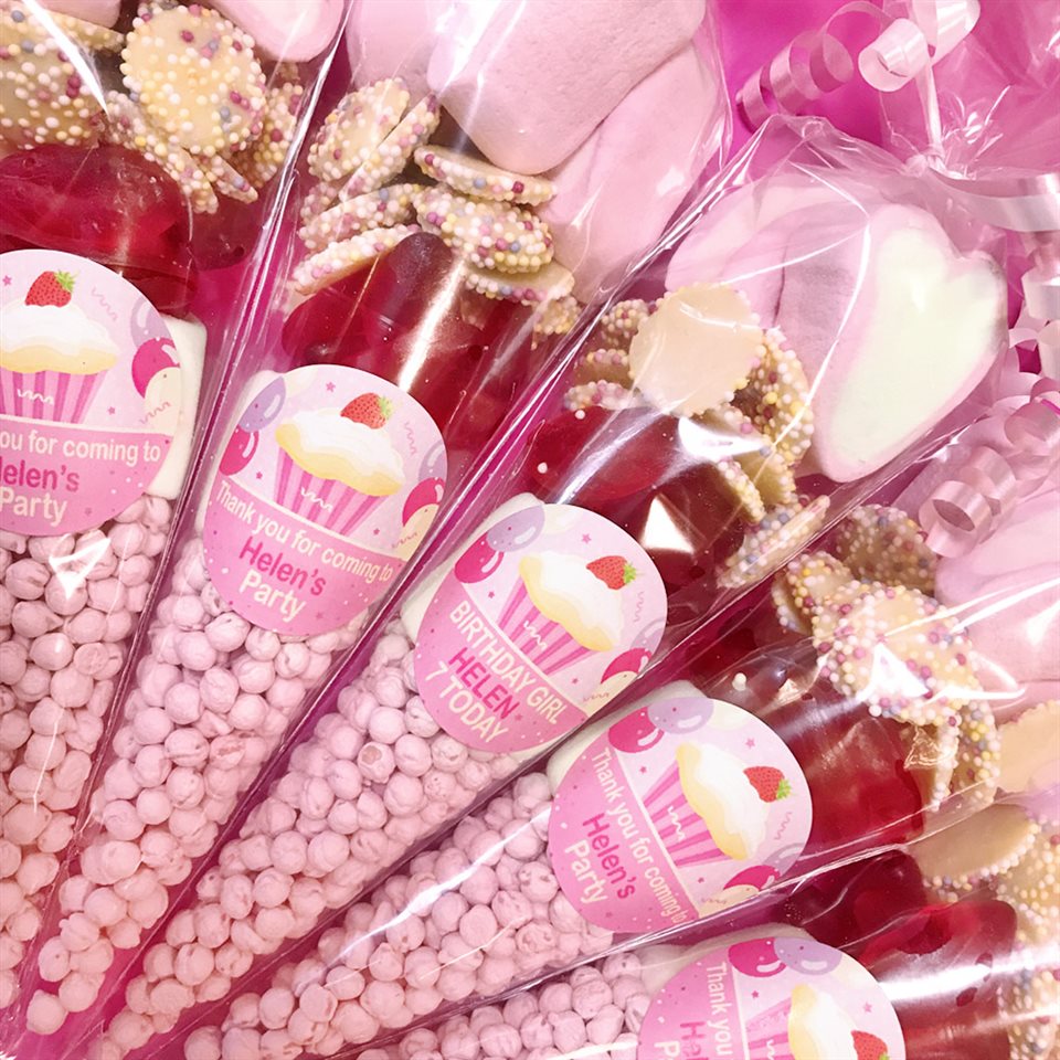 Party favors with pink and gold decorations and 'Helen's Party' labels.