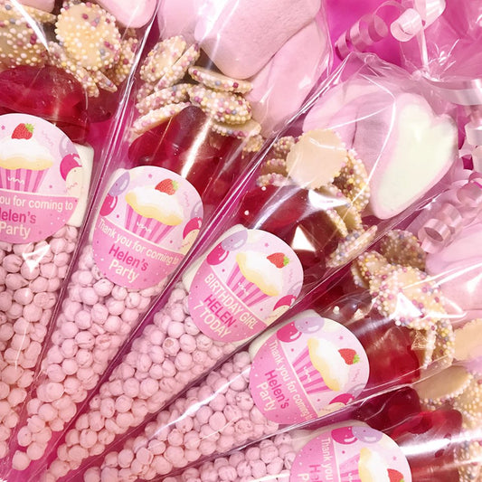 Party favors with pink and gold decorations and 'Helen's Party' labels.