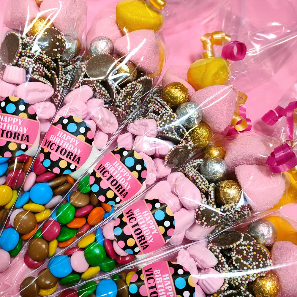 Assorted candies in clear packaging with 'Happy Birthday' labels.
