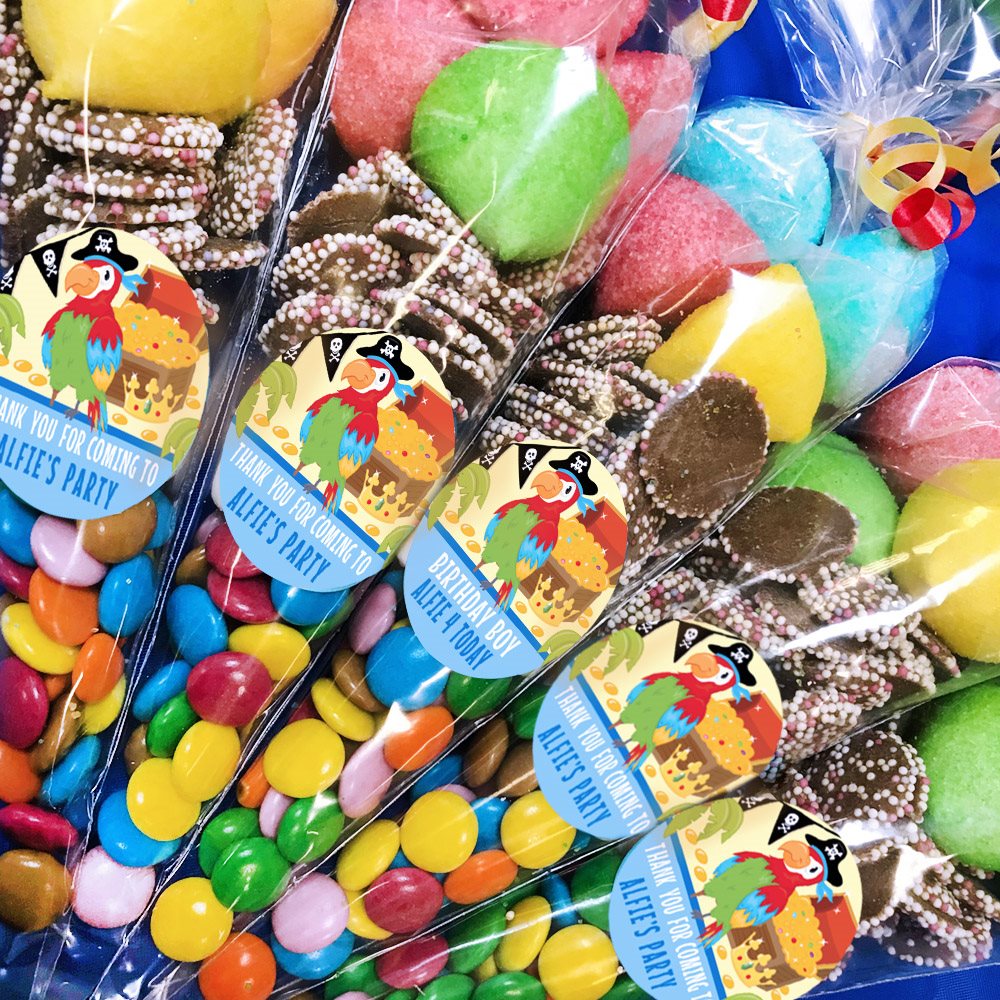 Colorful candy packages with pirate-themed labels on a table.