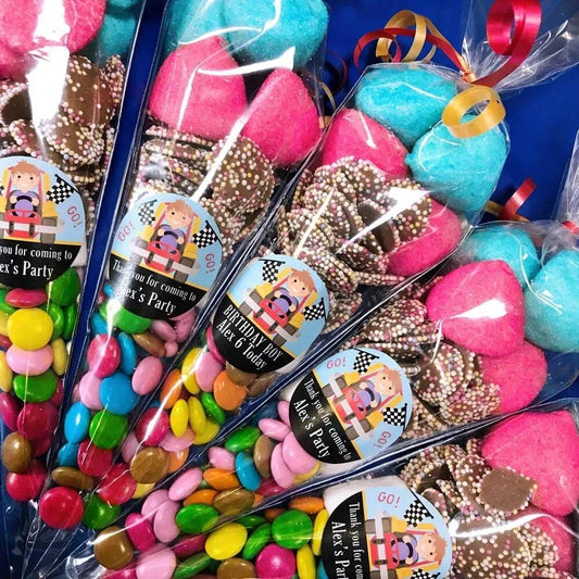 Pre-filled sweet cone party bags with racing-themed decorations and a variety of colorful candies visible.