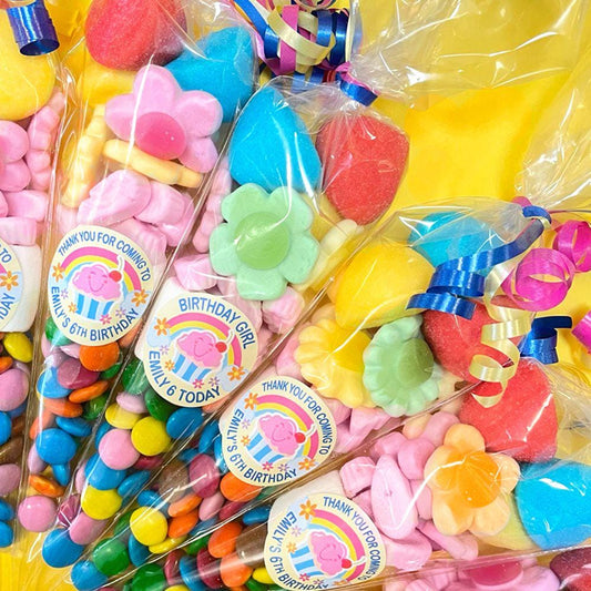 Pre-filled sweet cones with a variety of colorful candies and stickers, packaged in transparent wrapping.