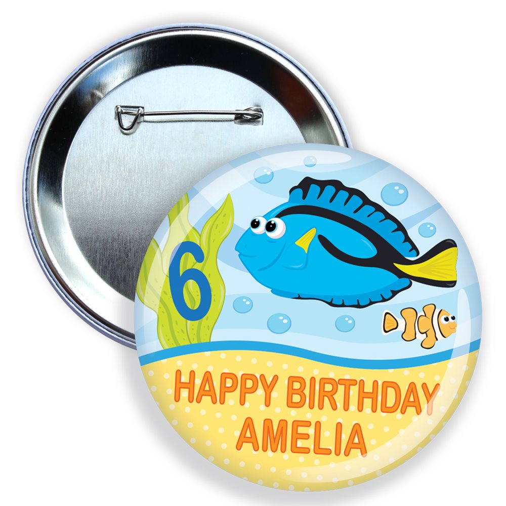 Button badge with a blue fish design, number 6, and text 'Happy Birthday Amelia' on a white background.