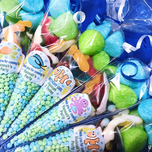 Pre-filled sweet cones with various colorful candies, each cone is adorned with stickers featuring sea animal designs.