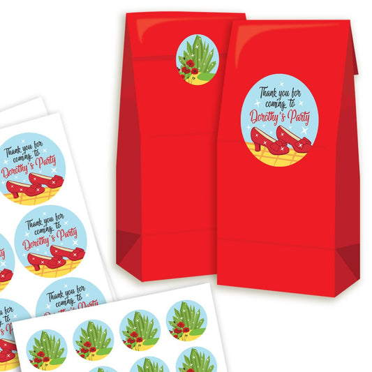 Red party favour bags with decorative stickers featuring Wizard of Oz-themed graphics on a white background.