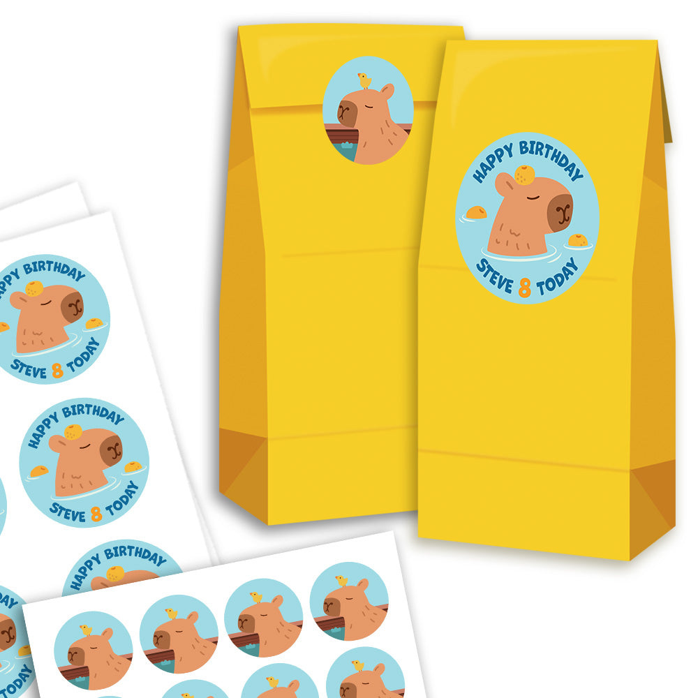 Yellow gift bags with cartoon capybara design and 'Happy Birthday' text on a white background