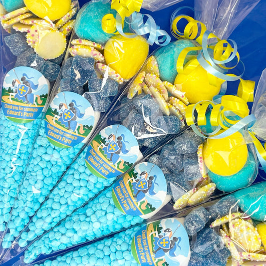 Assorted party favours including blue and yellow items with branded labels on a blue background.