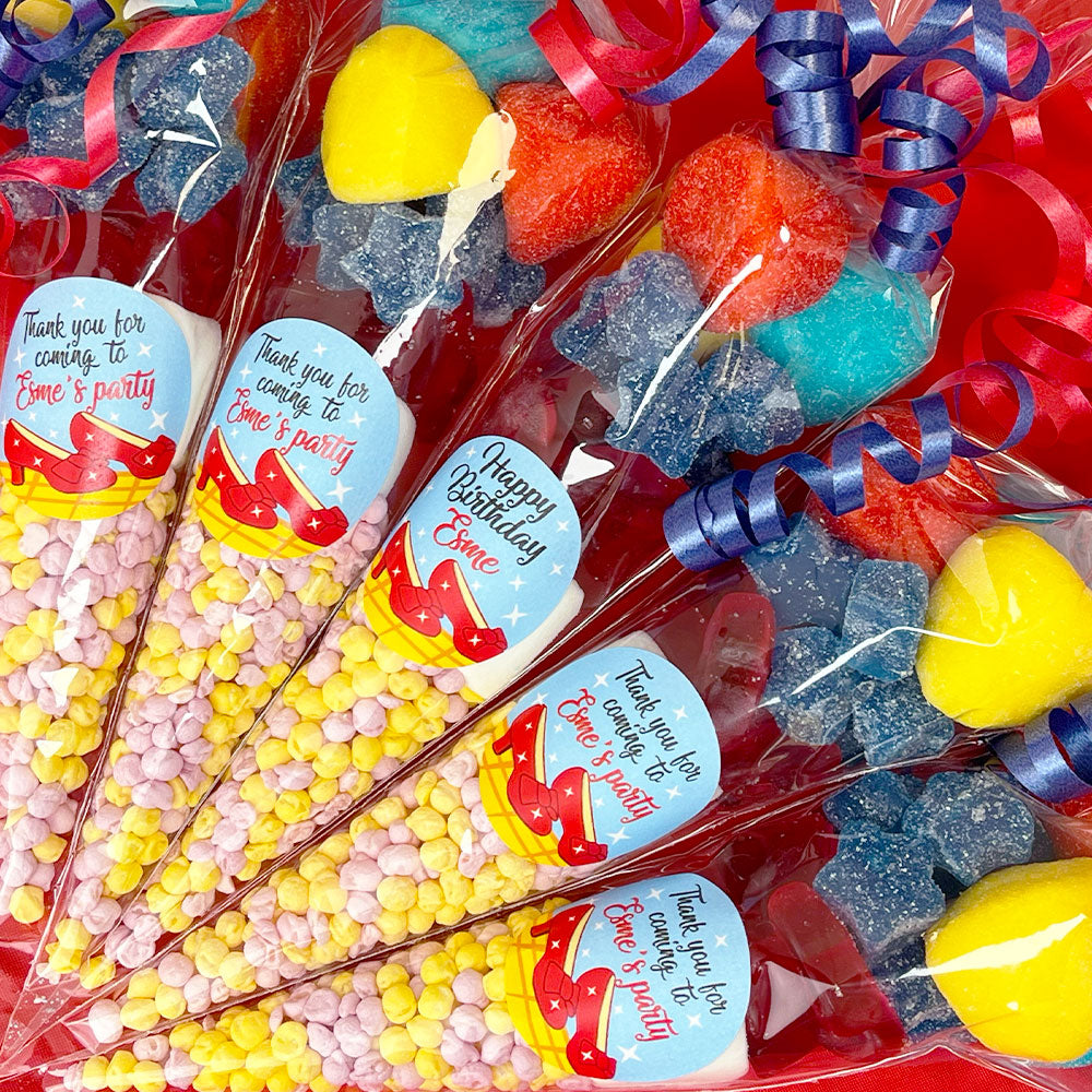 Colorful candy bags with personalized labels on a red background